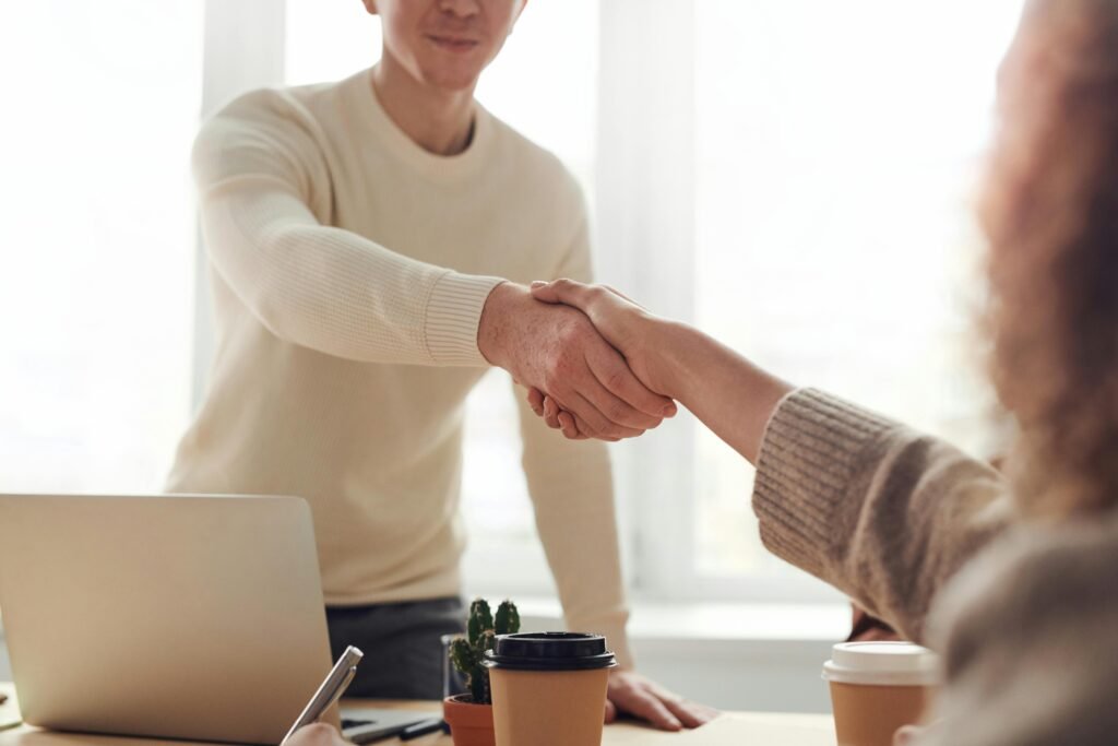 Satisfied client shaking hands with a web designer