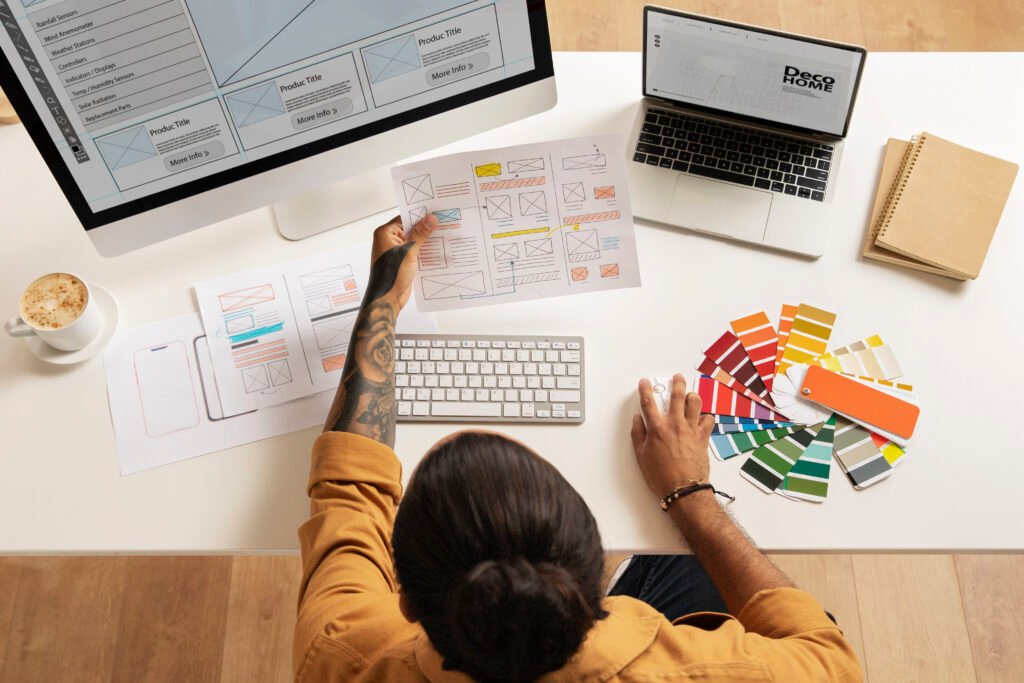 Web designer working on laptop, creative office setup